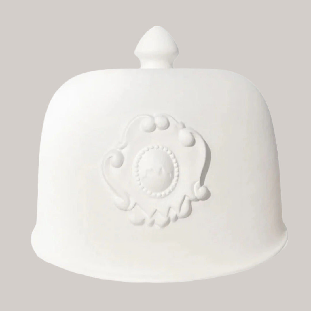 White ceramic jar with decorative emblem on a white background