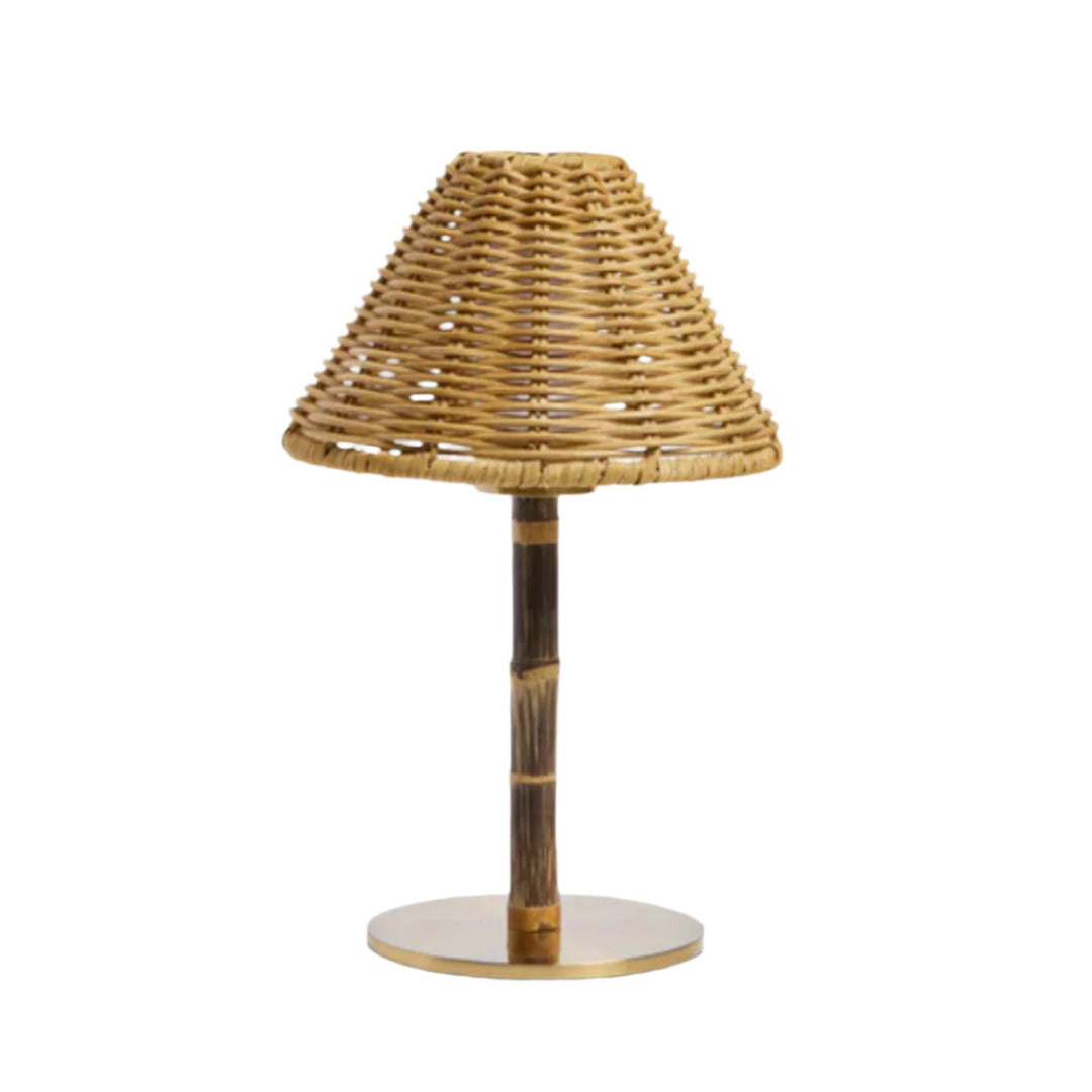 Table lamp with wicker shade and wooden base on a white background